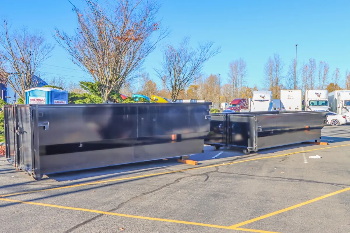 Professional dumpster rental service with roll-off container on residential driveway in Trumbull